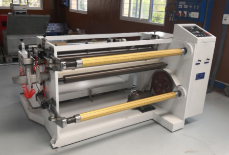 Detailed view of the tension control and cutting mechanism on the polyester film slitting equipment